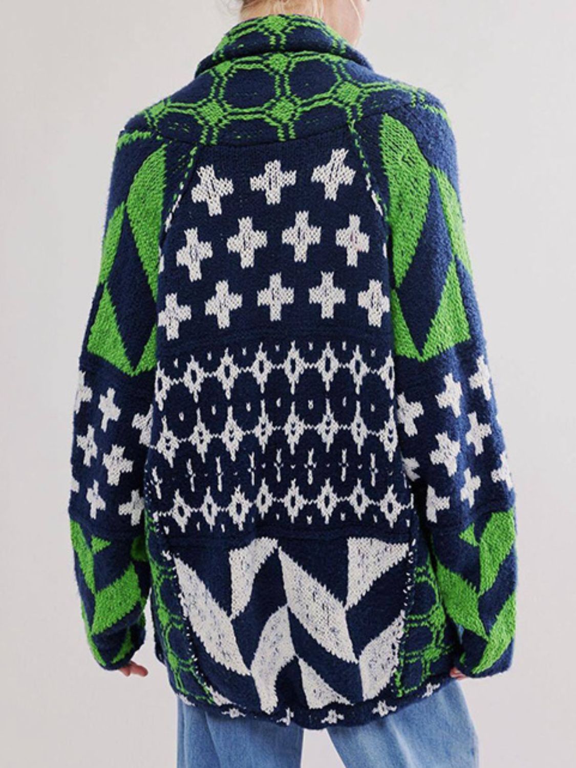 Geometric patchwork knit cardigan in navy with green and white patterns.