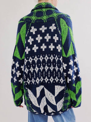 Geometric patchwork knit cardigan in navy with green and white patterns.