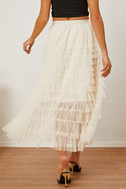 Tiered tulle maxi skirt in ivory with ruffled layers, shown with a black crop top.