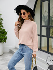 Blush pink textured mock neck sweater with long sleeves.