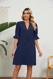 Navy V-neck shift dress with flutter sleeves and a notched neckline.