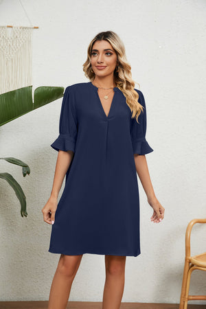 Navy V-neck shift dress with flutter sleeves and a notched neckline.