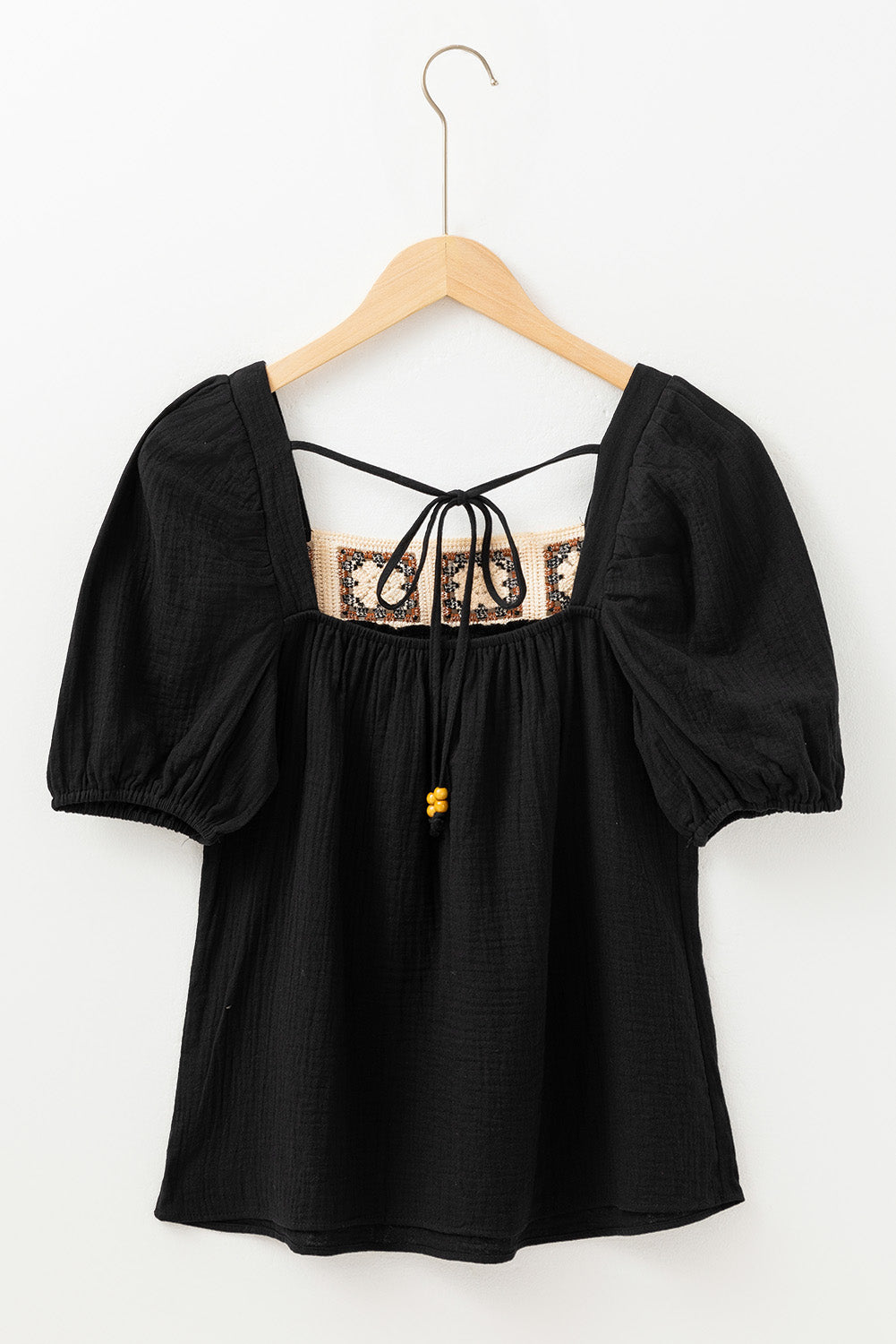Black gauze puff sleeve blouse with crochet yoke and tie detail