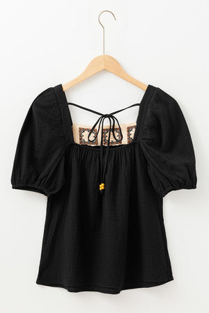 Black gauze puff sleeve blouse with crochet yoke and tie detail