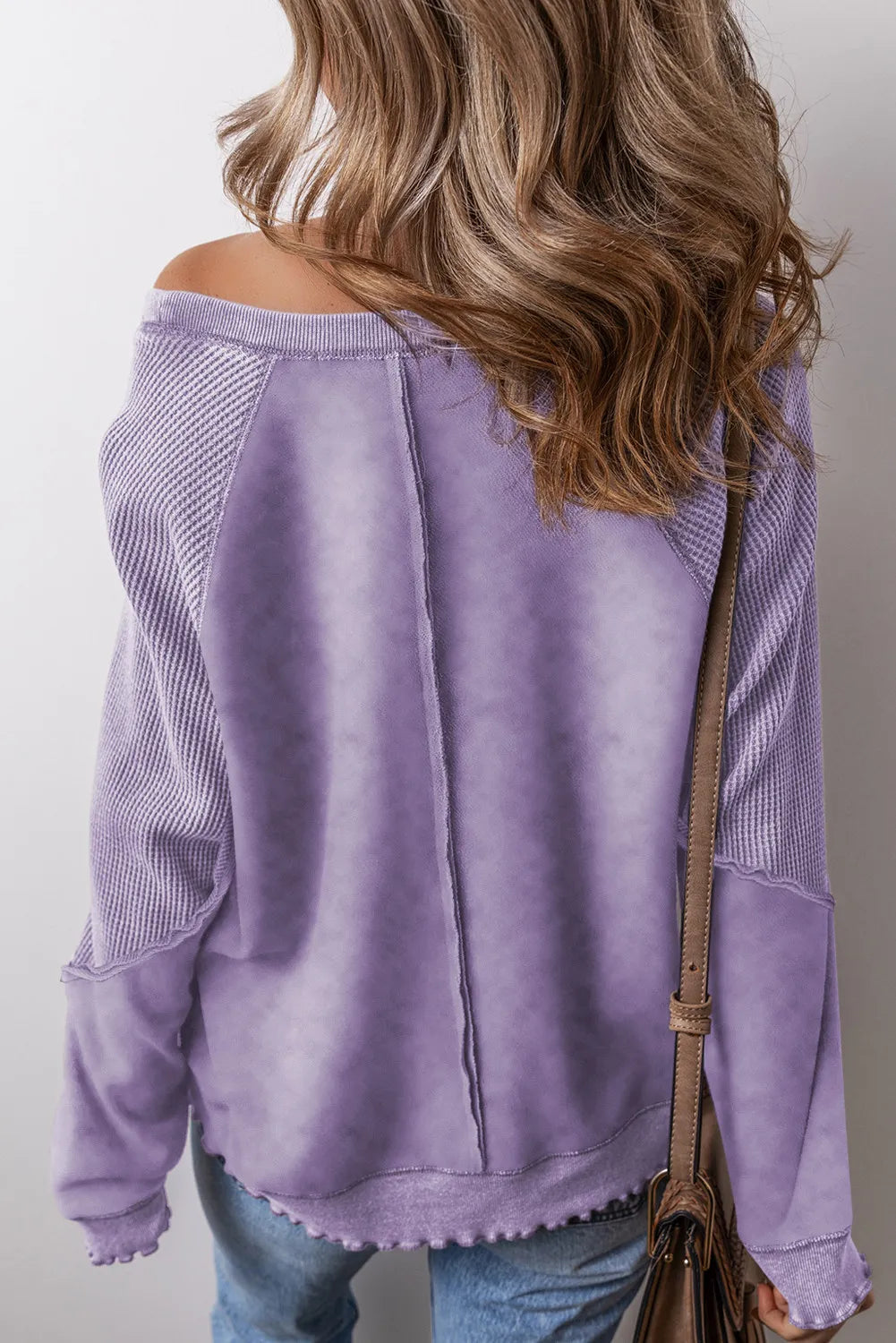 Lavender waffle knit sweatshirt with raglan seams and textured sleeves.