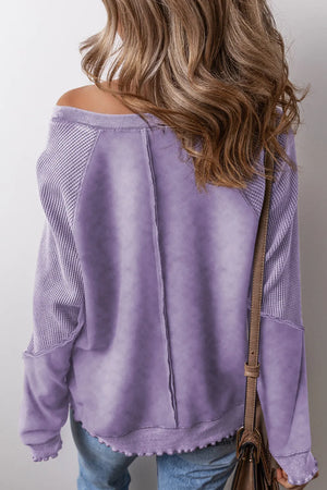 Lavender waffle knit sweatshirt with raglan seams and textured sleeves.