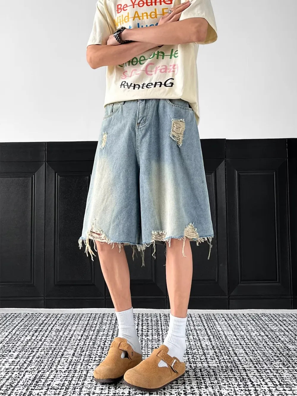 Light-wash denim shorts with distressed rips and frayed hem.