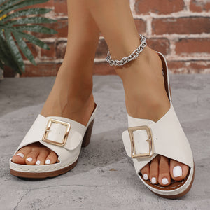 White block heel sandals with gold buckle detail and platform sole.