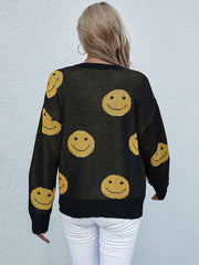 Black smiley face jacquard knit sweater with crewneck and long sleeves.
