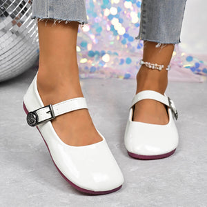 White buckle strap Mary Jane loafers with a rose detail on the buckle.