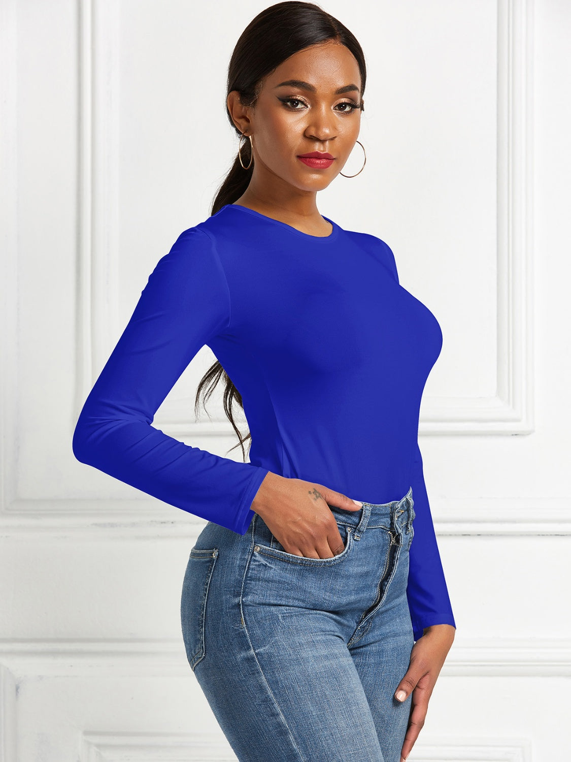 Royal Blue long sleeve ribbed bodysuit with crew neck, styled with jeans.