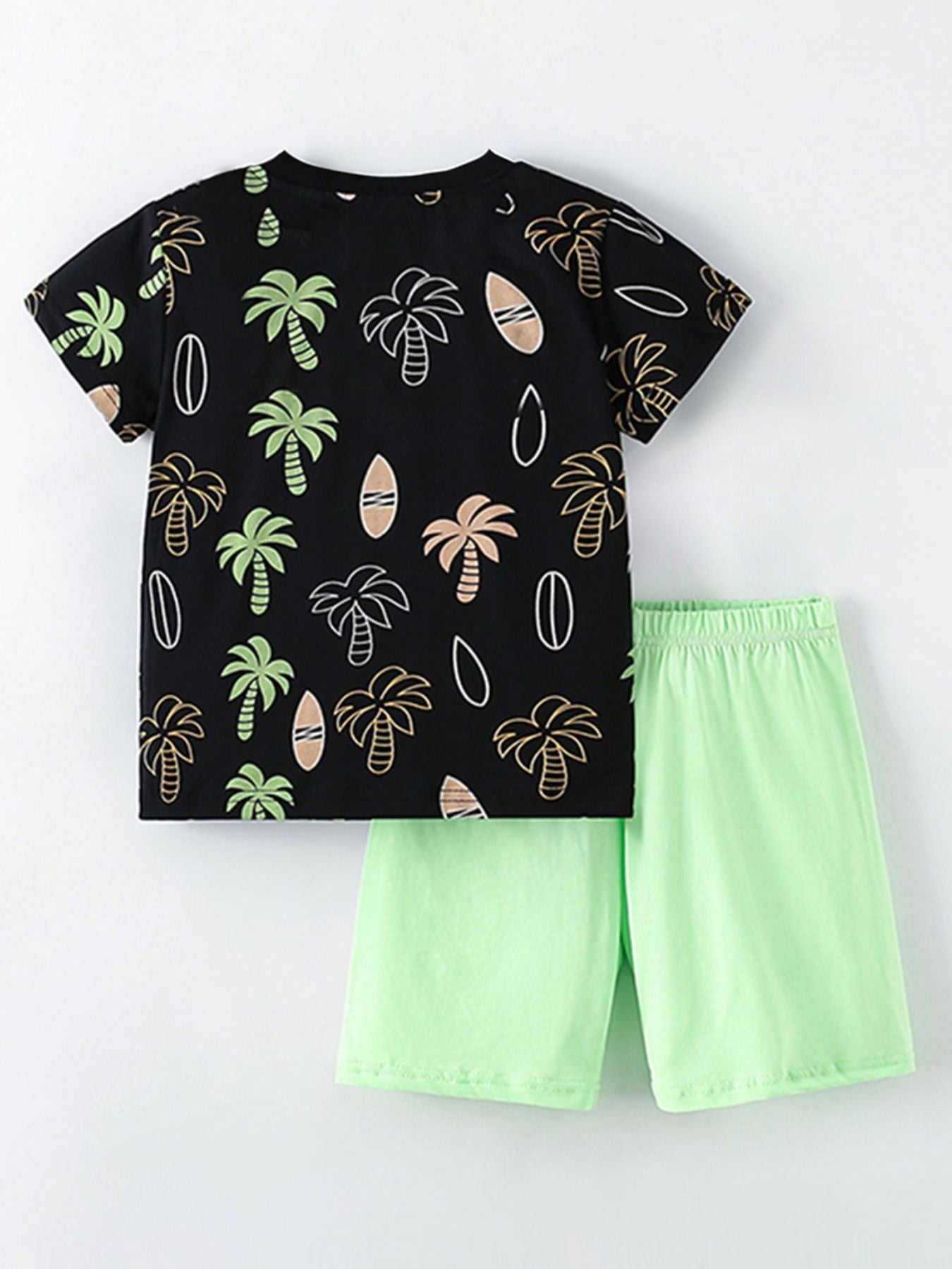 Boys' black cotton tee with tropical palm tree print and light green shorts.