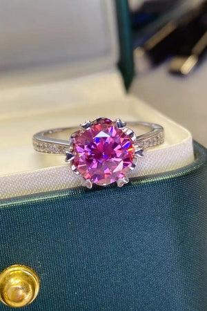 Pink moissanite and sterling silver ring with floral-inspired setting and pavé band.