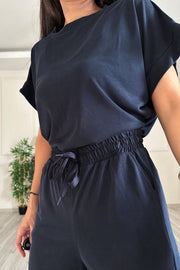 Dark blue relaxed fit tee with cuffed sleeves and wide leg pants with drawstring waist