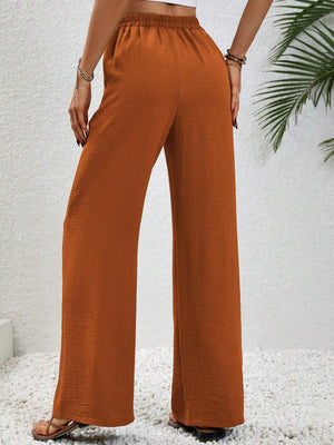 Caramel textured palazzo trousers with drawstring waist and wide legs.