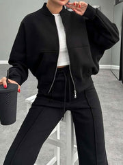 Black bomber jacket with zipper and wide-leg track pants with drawstring waist