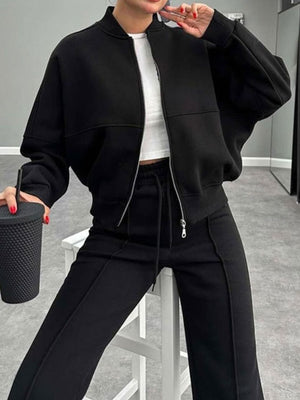 Black bomber jacket with zipper and wide-leg track pants with drawstring waist