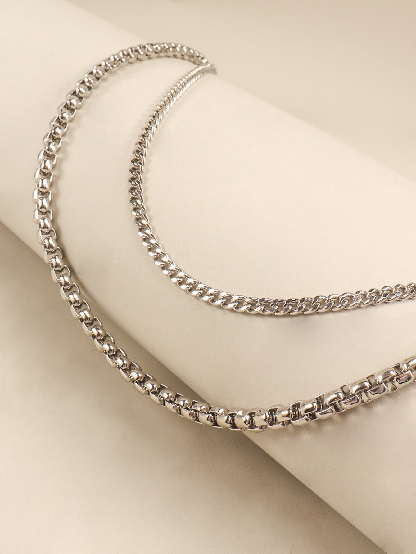 Silver double-strand chain pant accessory with box and curb link styles.