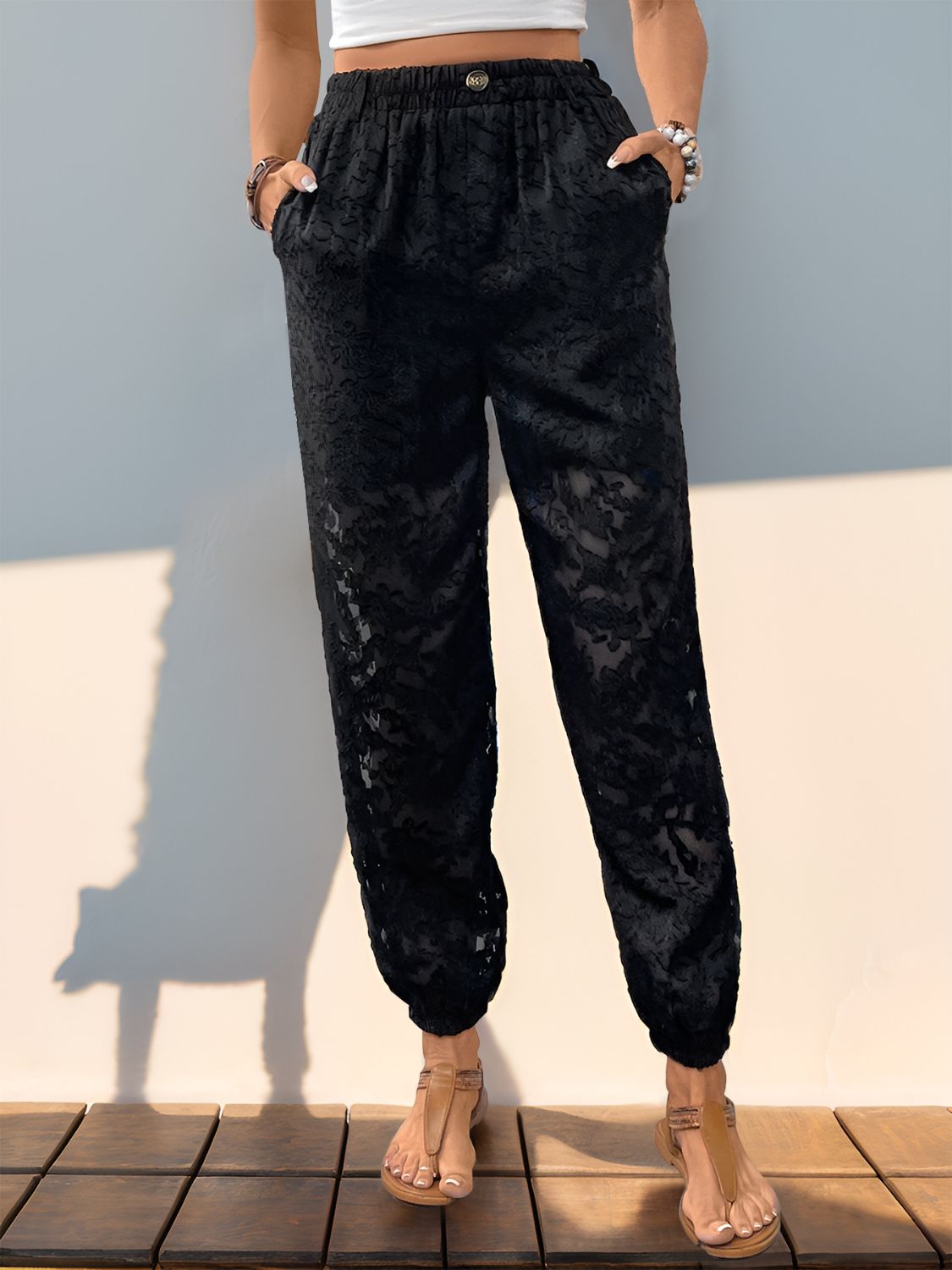 Black textured lace joggers with elastic waist and pockets