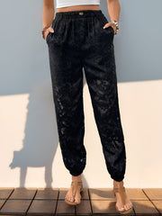 Black textured lace joggers with elastic waist and pockets