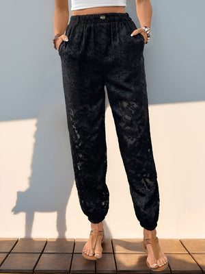 Black textured lace joggers with elastic waist and pockets