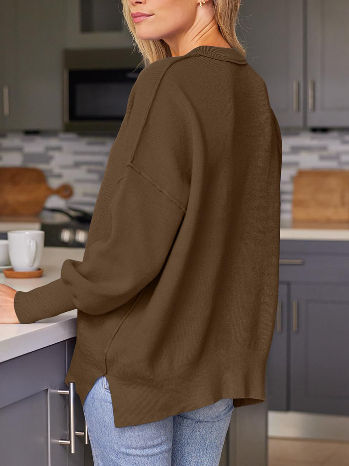 Ribbed-knit relaxed fit sweater in dark brown with a collared neckline and side slits.