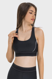 Black performance sports bra with white piping and double-stitched band