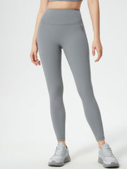Gray high-waisted leggings with side pocket detail and a seamless fit.