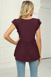 Ribbed wine flutter sleeve empire waist peplum blouse with ruffle detail.