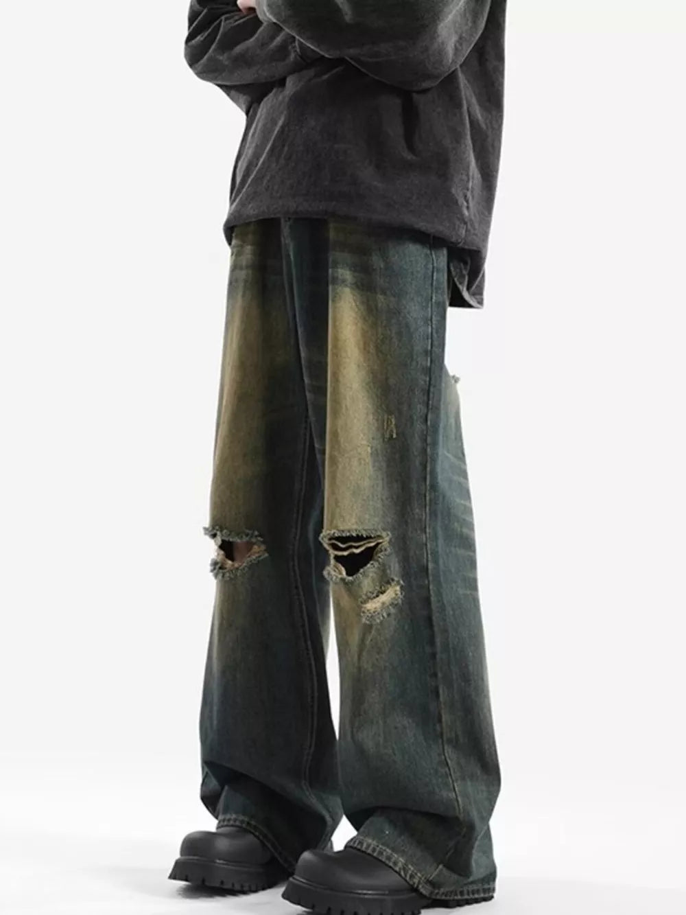 Men's vintage distressed wide-leg jeans in blue denim with ripped knees.