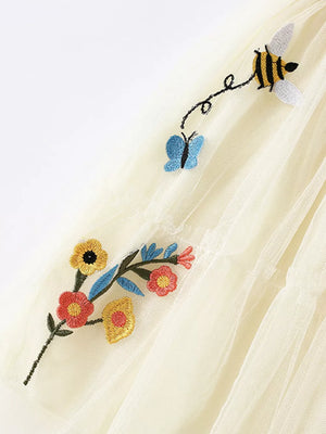 Cream tulle tiered toddler dress with embroidered bees, butterflies, and flowers.