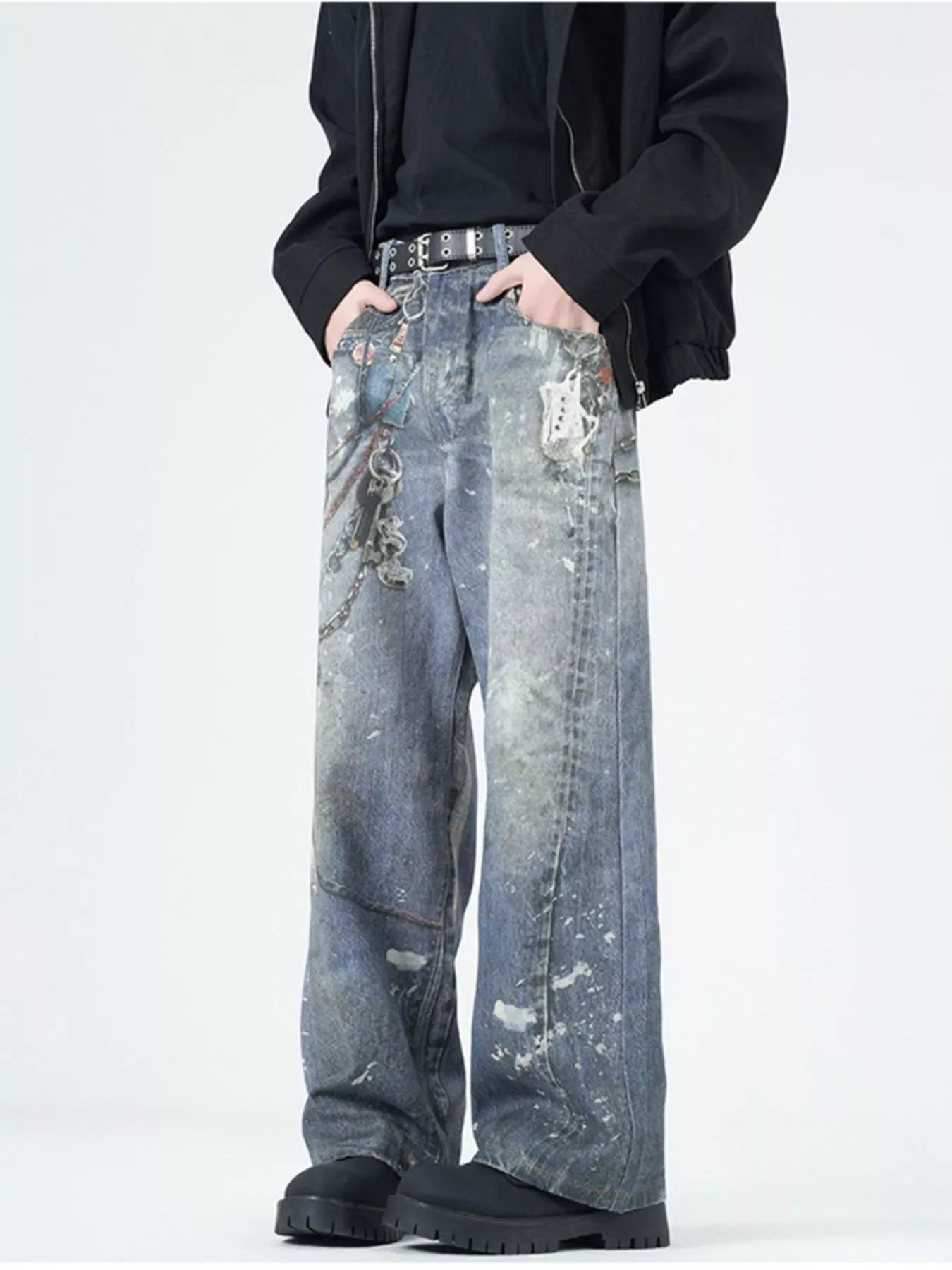 Men's wide-leg jeans in dusty blue denim with paint splatters and chain detail.