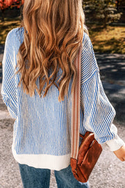 Light blue and white striped knit sweater with drop shoulders and a ribbed hem.