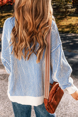 Light blue and white striped knit sweater with drop shoulders and a ribbed hem.