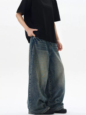 Oversized vintage-finish men's baggy jeans in dark wash denim with distressed details.