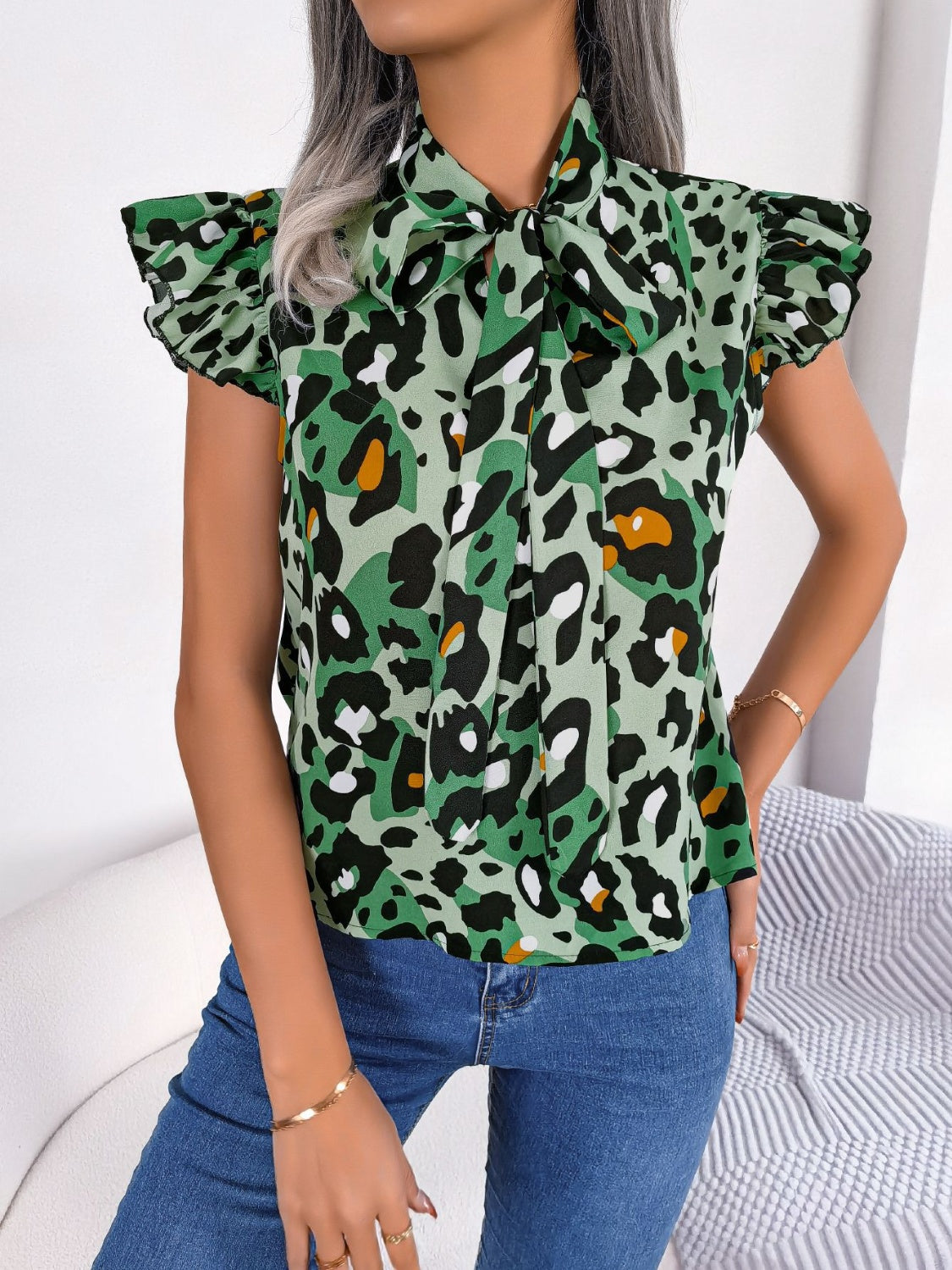 Green leopard print blouse with ruffled sleeves and pussybow tie neckline
