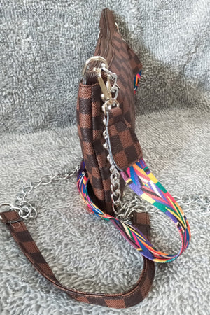 Brown checkered print shoulder bag with colorful strap and silver chain detail