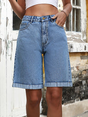 Light wash denim bermuda shorts with rolled hems and button fly.