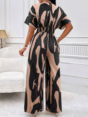 Black and beige abstract print wide-leg romper with short sleeves and elastic waist