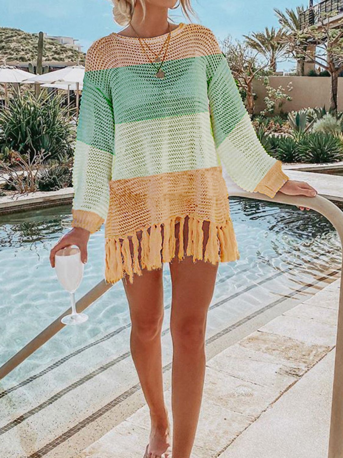 Open-knit beach cover-up with fringe hem in pastel stripes and peach.