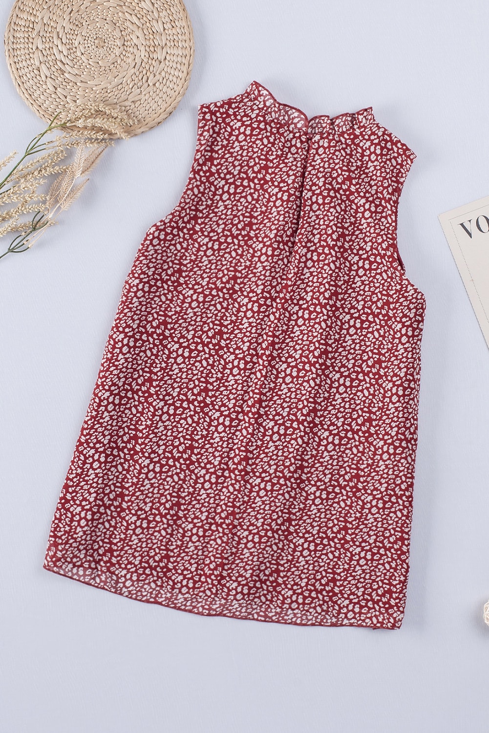 Burgundy printed sleeveless blouse with ruffled neckline