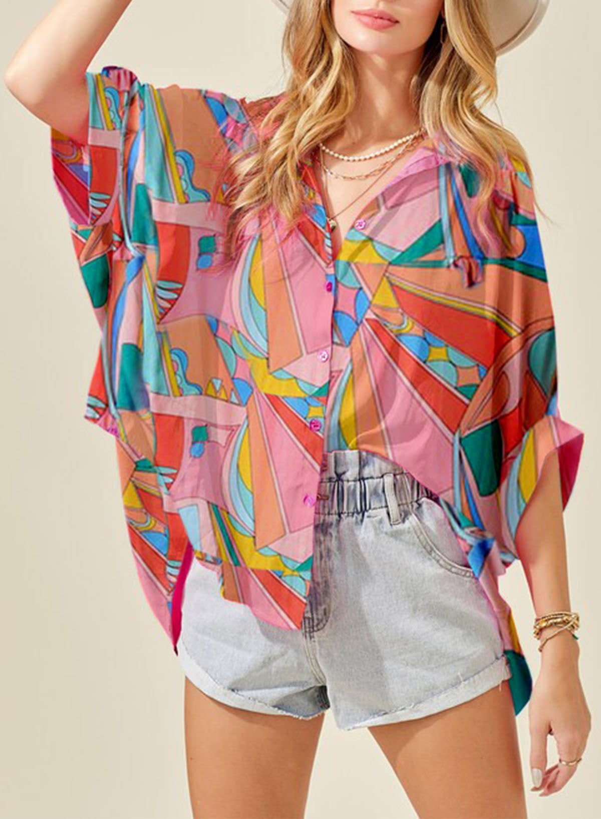 Multicolor psychedelic print batwing blouse with button front and short sleeves.