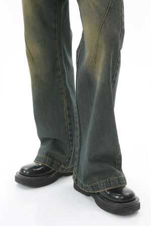 Faded wash flare denim trousers in dark, with a distressed look.