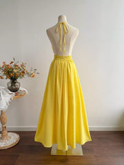 Yellow Swiss dot halter dress with a-line skirt and smocked waist.