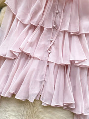 Pink chiffon blouse with tiered ruffles, button front, and bow tie detail.