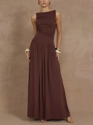 Brown ruched maxi dress with asymmetric neckline and flowing skirt.