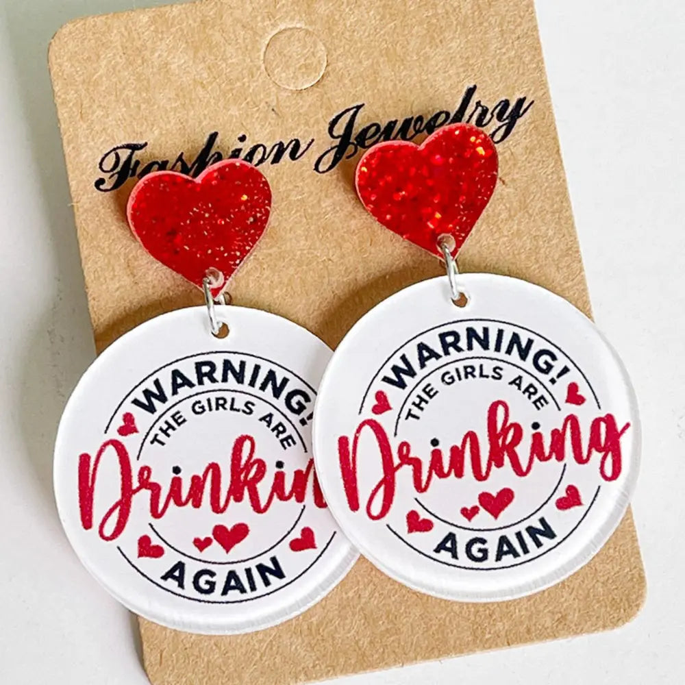 Red glitter heart acrylic drop earrings with "Warning! The Girls Are Drinkin Again" text