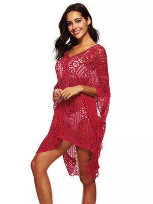 Red crochet V-neck beach cover-up with intricate cutout pattern and fringe detail.
