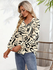 Women's abstract print blouson sleeve top in cream with black scribble pattern.