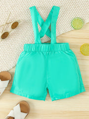 Turquoise cotton suspender shorts with elastic waistband and pockets.